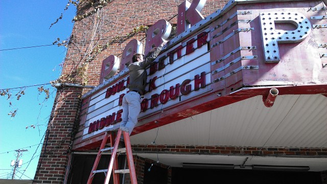 Every time I turned around, Mike Lydon was on the top of a ladder again. Having just met him that morning, I was pretty sure he was either fearless or nuts. He said that they found the letters in the abandoned theater the previous day and he had personally washed them off.